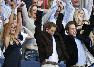 Chelsy Davy (L), boyfriend Prince Harry (C) and Prince William perform a mexican wave at Wembley stadium in north London, 01 July 2007, as 60 000 revellers join Princes William and Harry for the six-hour long extravaganza in memory of their late mother Diana. Prince William, who turned 25 on June 21, predicted it would be "an incredible night" of music after watching preparations being made yesterday for the event which is timed for what would have been his mother's 46th birthday. Police were on high alert as the huge concert got under way, a day after Britain raised its security threat level to maximum. Image: Leon Neal/AFP.