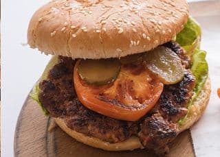 Juicy Lamb Burger with fries, tomato and pickles