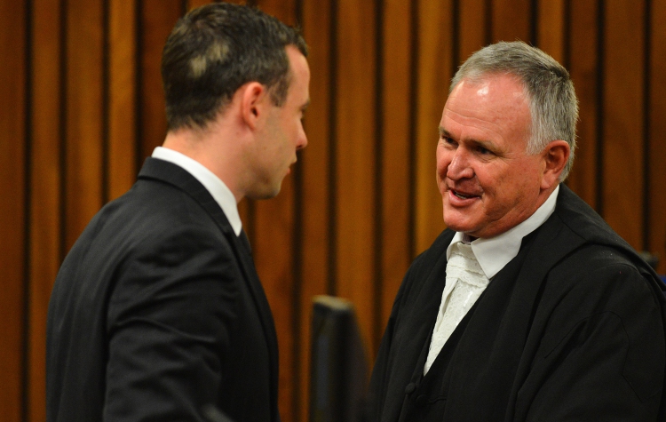 Oscar Pistorius in court with Barry Roux. Photo by Pool/Getty Images News 